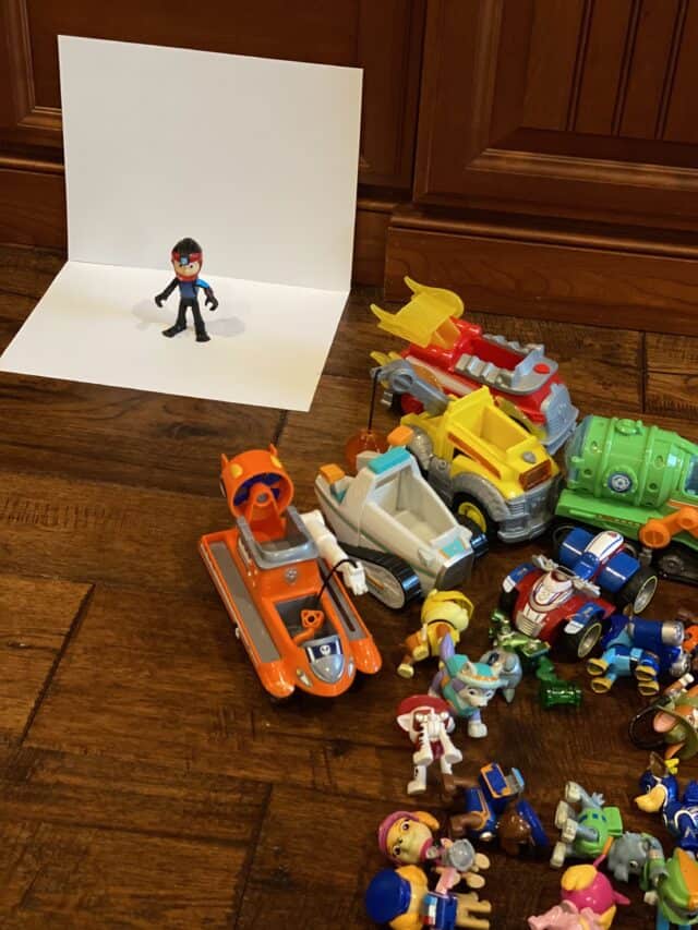 taking photos of Paw Patrol toys on a white backdrop